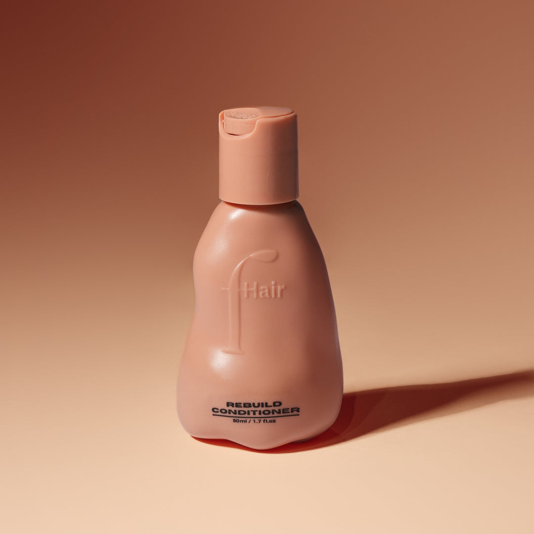Fhair Rebuild Conditioner 50ml travel size for damaged hair repair. Nourishes, smooths frizz and strengthens hair for a healthy shine.