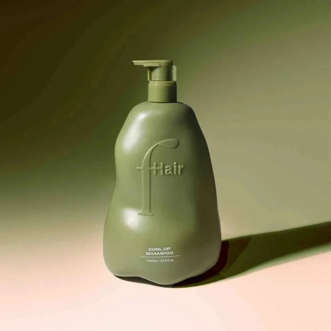 Curl Up Shampoo bottle with defined curls illustration promoting frizz control and hydration