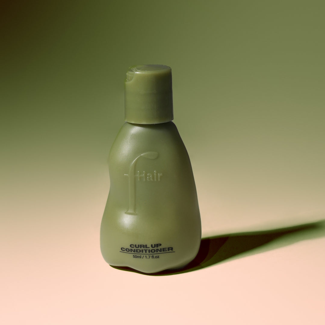 Fhair Curl Up Conditioner for curly hair. Hydrates, detangles and enhances curl definition for soft, bouncy, frizz-free curls.