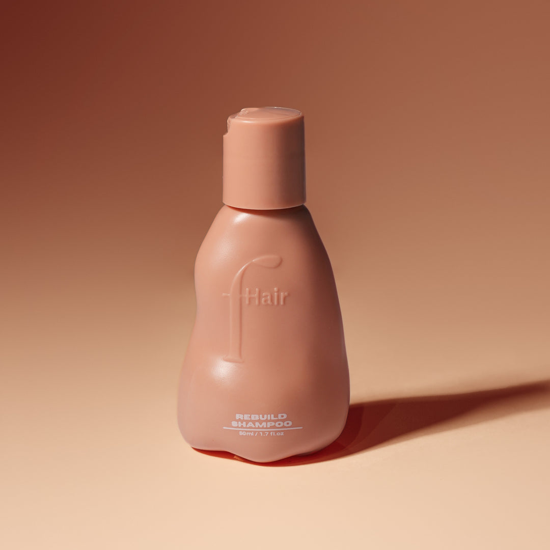 Fhair Rebuild Shampoo 50ml travel size for gentle cleansing and hair repair. Strengthens damaged hair while reducing frizz and adding shine.